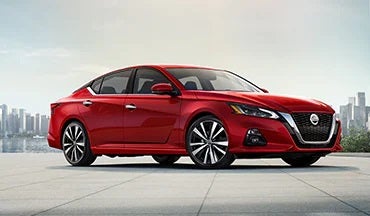 2023 Nissan Altima in red with city in background illustrating last year's 2022 model in Romeo Nissan in Kingston NY