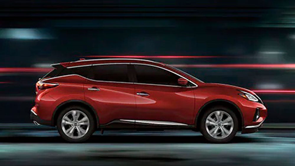 2023 Nissan Murano shown in profile driving down a street at night illustrating performance. | Romeo Nissan in Kingston NY