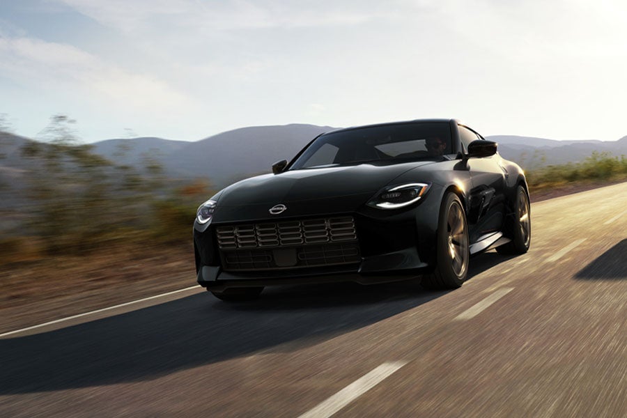 2024 Nissan Z in blue driving on a rural road at speed