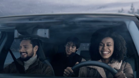 Three passengers riding in a vehicle and smiling | Romeo Nissan in Kingston NY